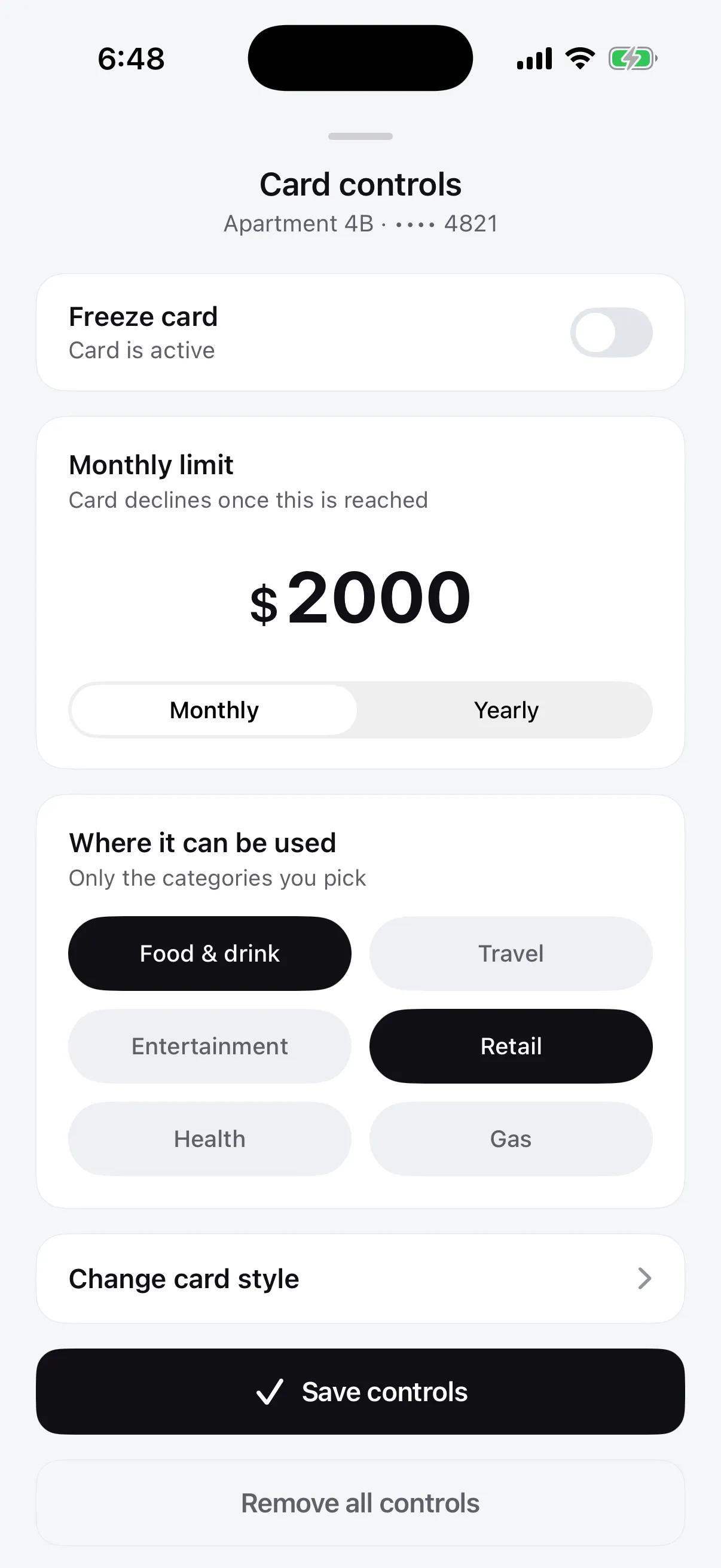 The Flint Card controls screen: the group card, a freeze toggle, a $2,000 monthly limit, and the categories the card is allowed at